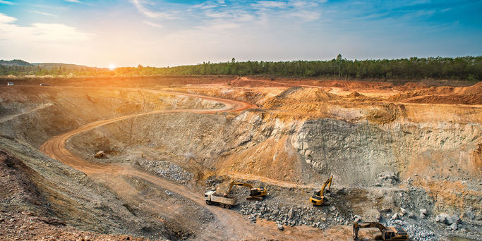 Opencast mining quarry with machinery at work Opencast mining quarry with machinery at work