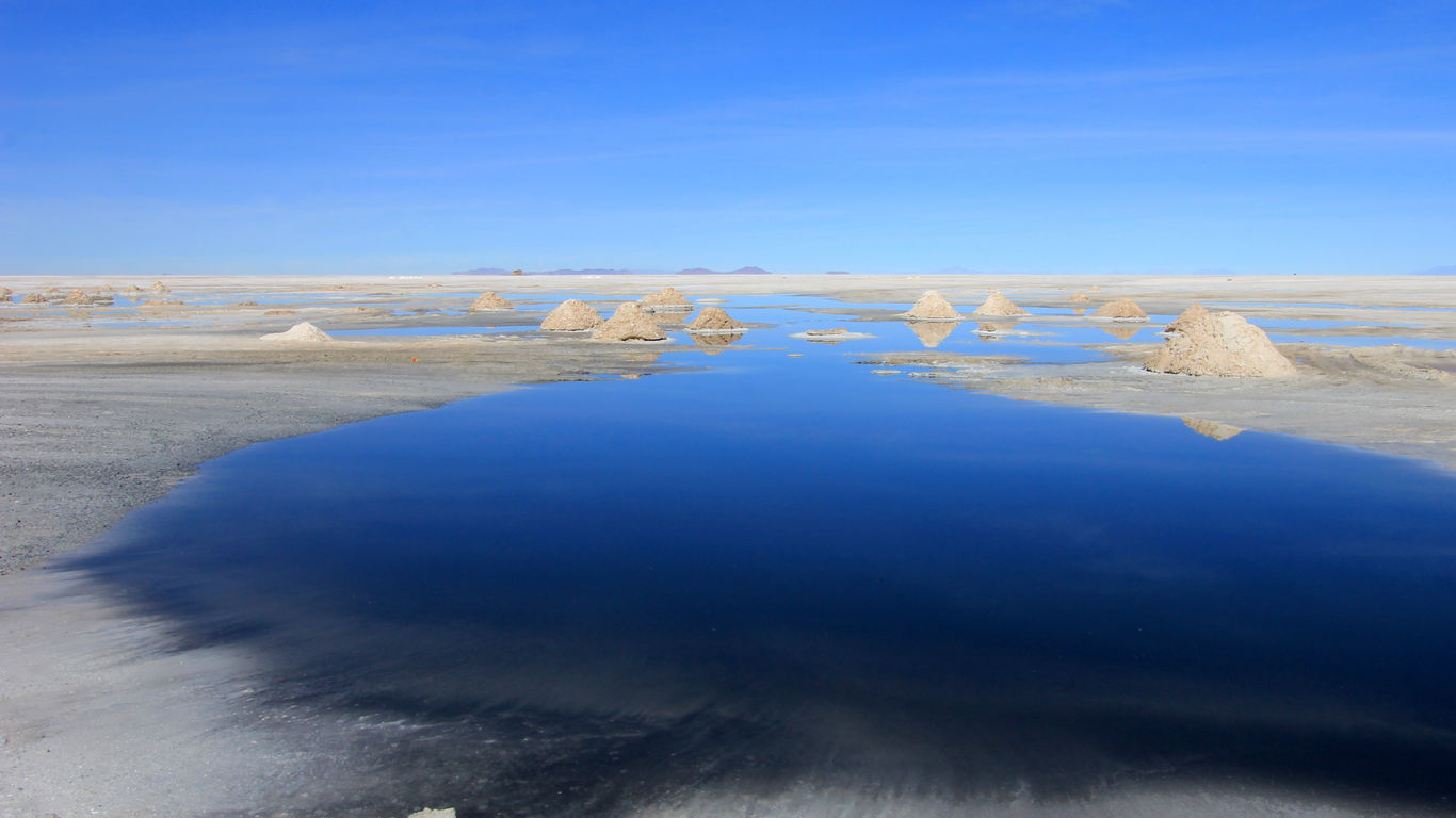 Hills of salt behind lake